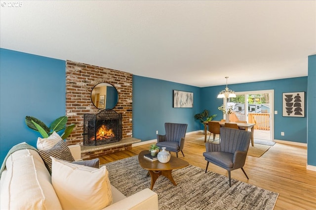 11995 SW 119th Ave, Portland, OR 97223 - living area with light wood-style floors, a chandelier, and a brick fireplace