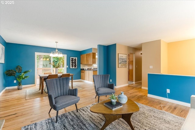 11995 SW 119th Ave, Portland, OR 97223 - living area with a chandelier, light wood finished floors, and a textured ceiling