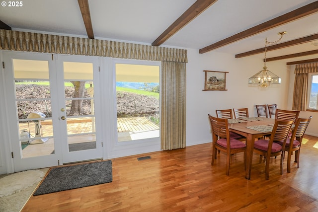 383 Little Valley Rd, Roseburg, OR 97471 - dining space featuring visible vents, beam ceiling, a chandelier, and wood finished floors