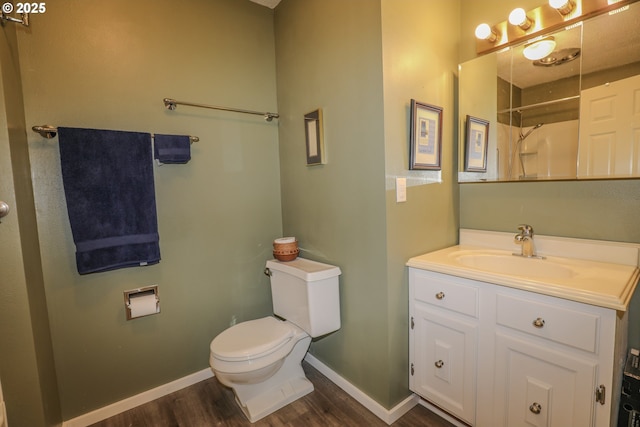 383 Little Valley Rd, Roseburg, OR 97471 - bathroom featuring vanity, toilet, a shower, wood finished floors, and baseboards