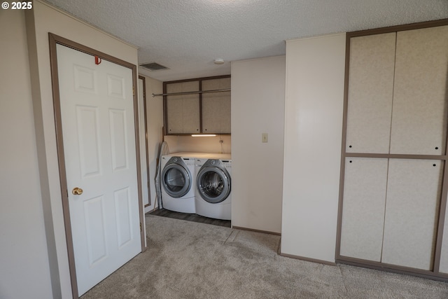 383 Little Valley Rd, Roseburg, OR 97471 - clothes washing area featuring visible vents, baseboards, a textured ceiling, independent washer and dryer, and light carpet