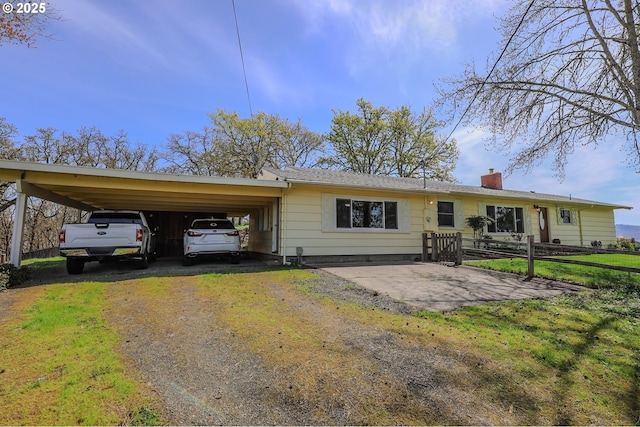 383 Little Valley Rd, Roseburg, OR 97471 - rear view of property with fence, an attached carport, driveway, and a chimney