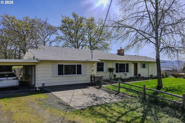 383 Little Valley Rd, Roseburg, OR 97471 - ranch-style house featuring fence, a front lawn, a chimney, a shingled roof, and an attached carport