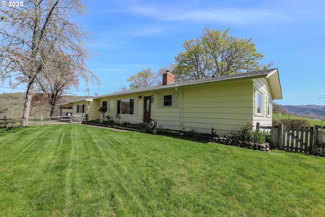 383 Little Valley Rd, Roseburg, OR 97471 - rear view of property featuring fence, a lawn, and a chimney