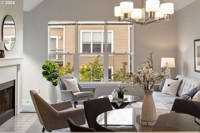 tiled living room with lofted ceiling and a notable chandelier