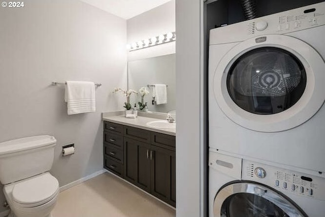 clothes washing area featuring sink and stacked washer / drying machine