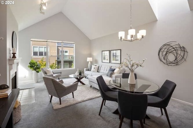1710 S Harbor Way Unit C405, Portland, OR 97201 - dining area with a chandelier, carpet, high vaulted ceiling, baseboards, and a fireplace
