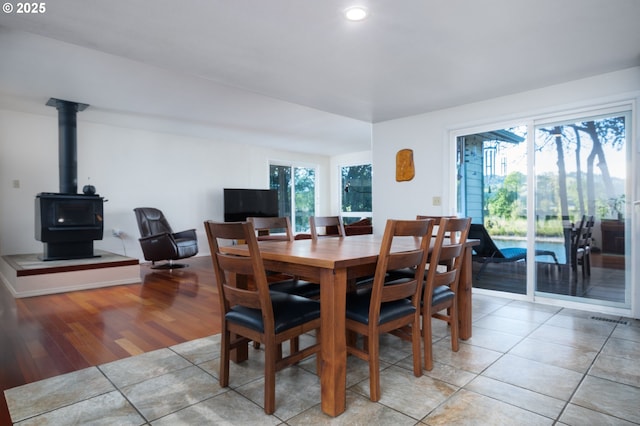 15928 N Umpqua Hwy, Roseburg, OR 97470 - dining area featuring light tile patterned floors, recessed lighting, and a wood stove