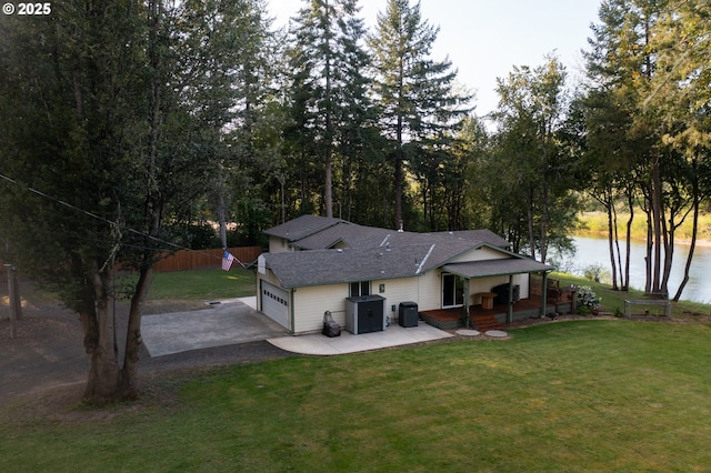 15928 N Umpqua Hwy, Roseburg, OR 97470 - back of property with asphalt driveway, a garage, a water view, roof with shingles, and covered porch