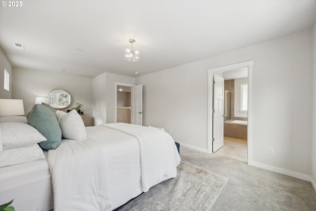 carpeted bedroom with ensuite bathroom and a notable chandelier