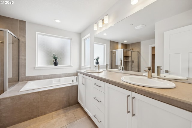 bathroom featuring tile patterned floors, independent shower and bath, and vanity