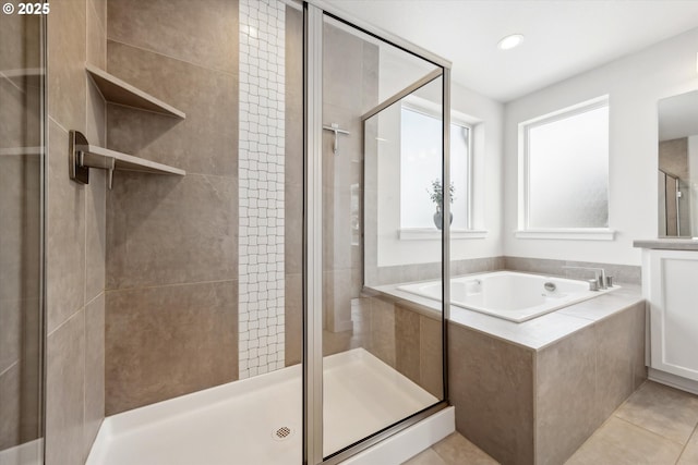 bathroom featuring tile patterned floors and separate shower and tub