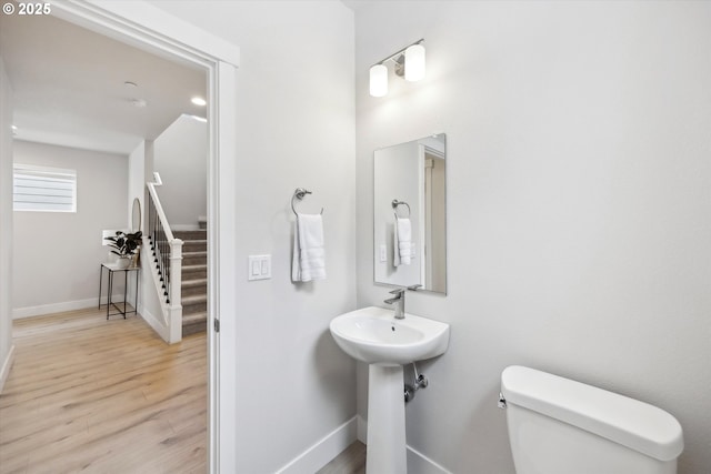 bathroom with toilet and hardwood / wood-style floors