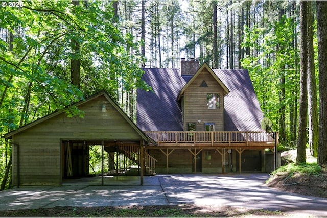 18020 SW Neugebauer Rd, Hillsboro, OR 97123 - view of front facade featuring concrete driveway, a wooden deck, a chimney, a shingled roof, and stairs