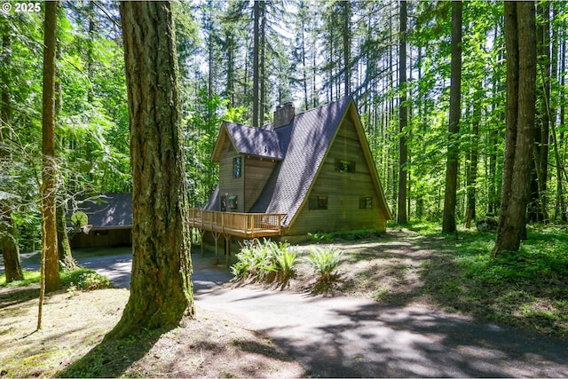 18020 SW Neugebauer Rd, Hillsboro, OR 97123 - view of front of house with a chimney, a deck, and a forest view