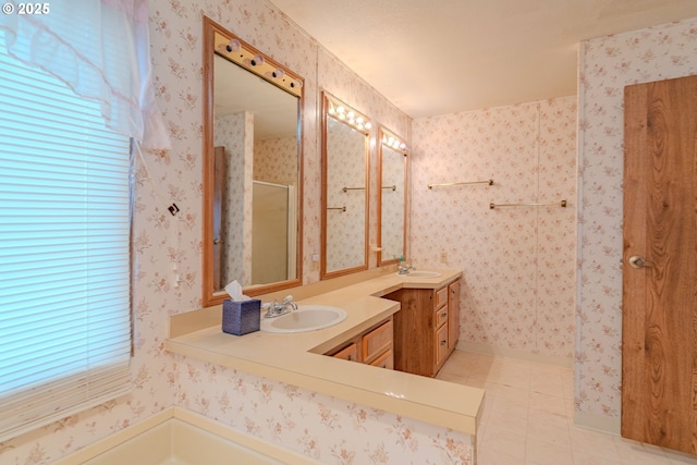 full bathroom with tile patterned flooring, a shower stall, wallpapered walls, and a sink