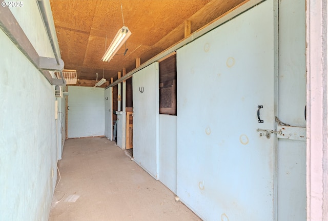 corridor with unfinished concrete floors