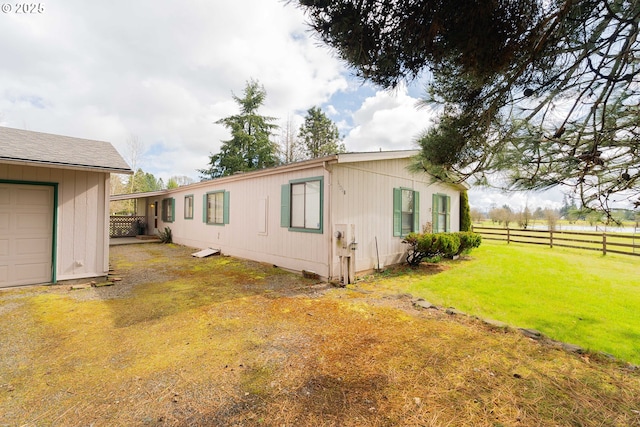 view of home's exterior featuring a yard and fence