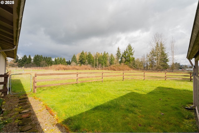 view of yard featuring a rural view and fence