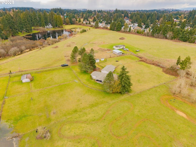 birds eye view of property with a rural view and a water view