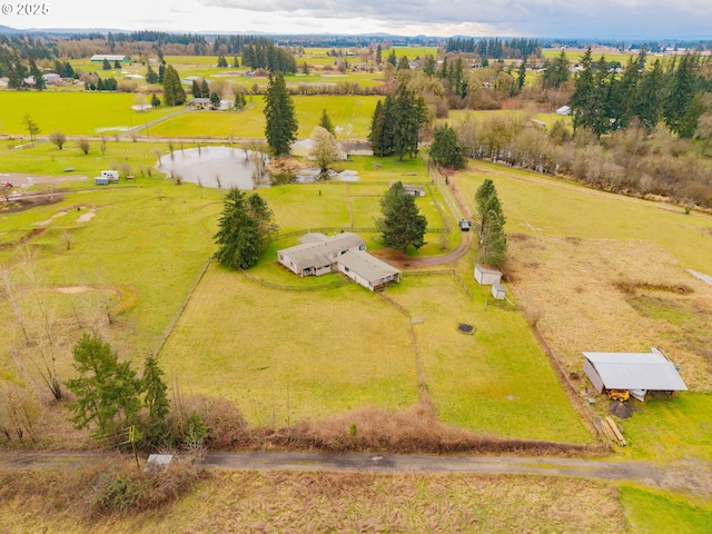 birds eye view of property featuring a rural view and a water view