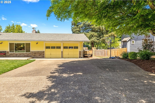 view of front of home with fence, driveway, an attached garage, a chimney, and stone siding