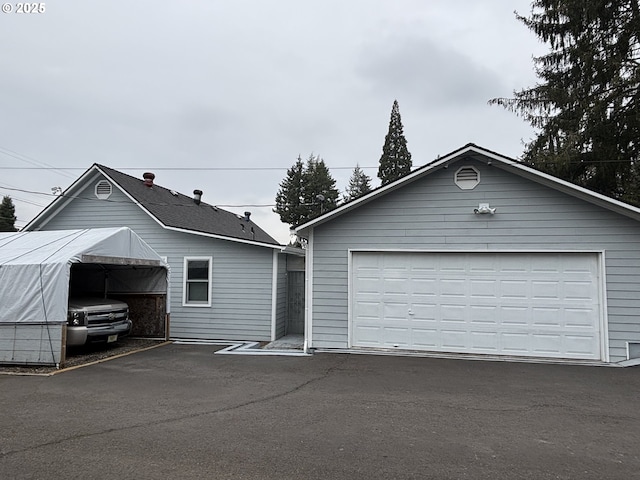 view of front of property featuring a garage and an outdoor structure