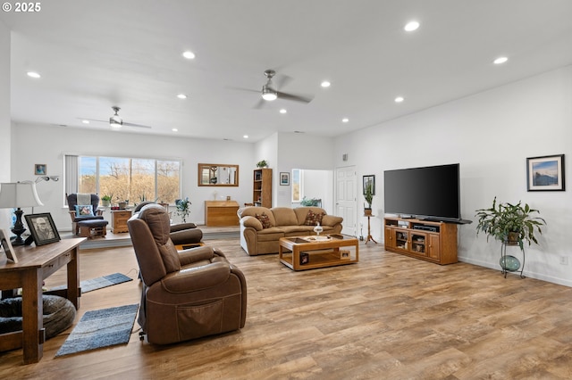 living area with light wood finished floors and recessed lighting