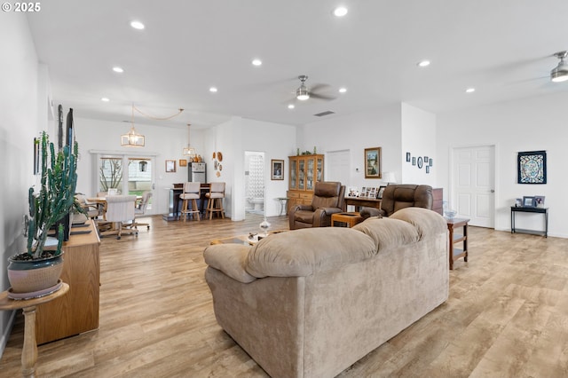 living area with ceiling fan, light wood-style floors, visible vents, and recessed lighting