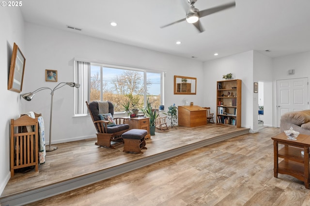 living area with recessed lighting, a ceiling fan, baseboards, visible vents, and light wood-style floors