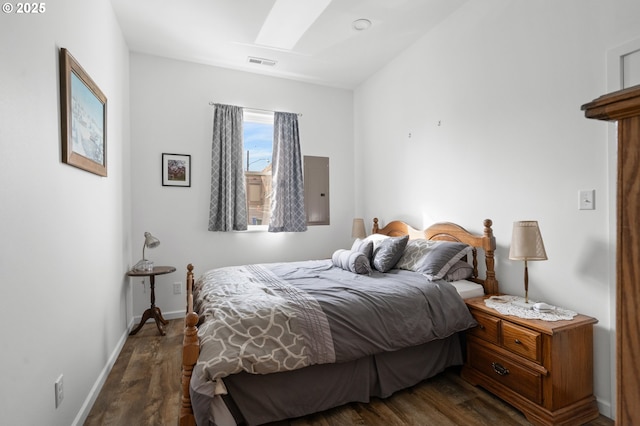 bedroom featuring baseboards, visible vents, and wood finished floors