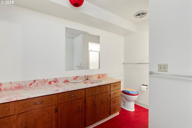 bathroom featuring toilet and vanity