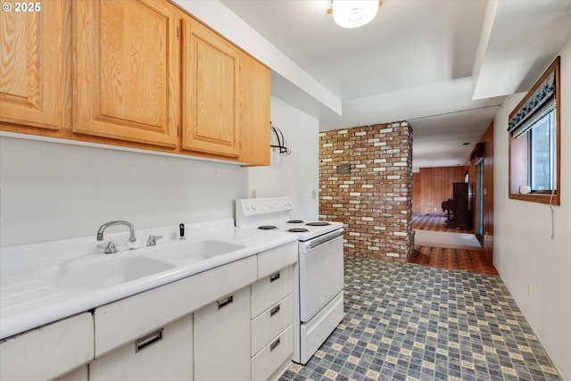 kitchen with sink, light brown cabinetry, and electric stove