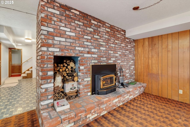 carpeted living room featuring a textured ceiling and wooden walls