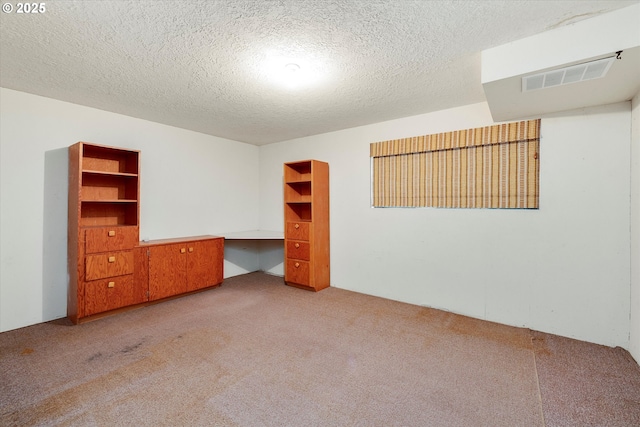 unfurnished bedroom with light carpet and a textured ceiling