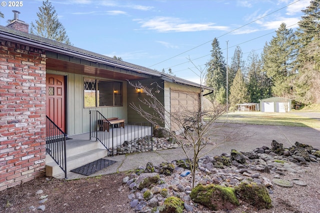 view of home's exterior featuring a garage and a shed