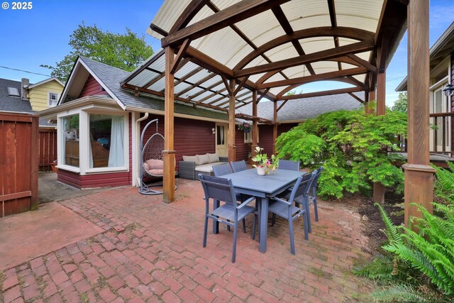 view of patio / terrace featuring a gazebo, fence, and outdoor dining space