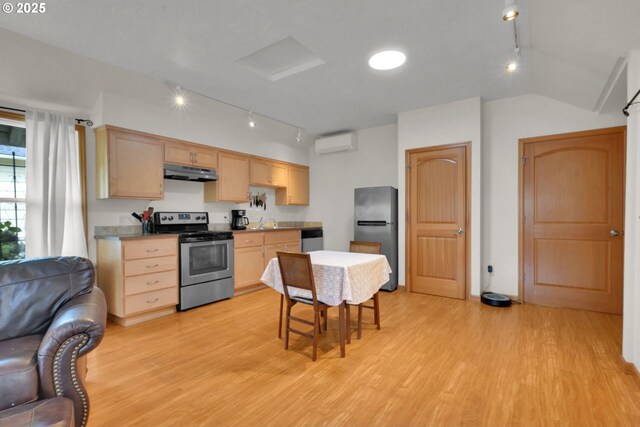 kitchen with track lighting, light brown cabinetry, under cabinet range hood, and stainless steel appliances
