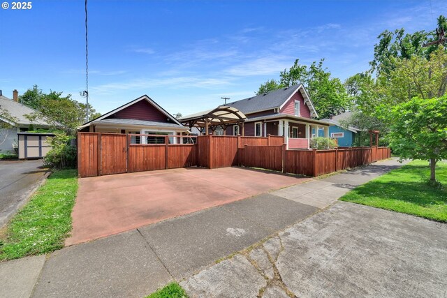 bungalow-style home with a fenced front yard