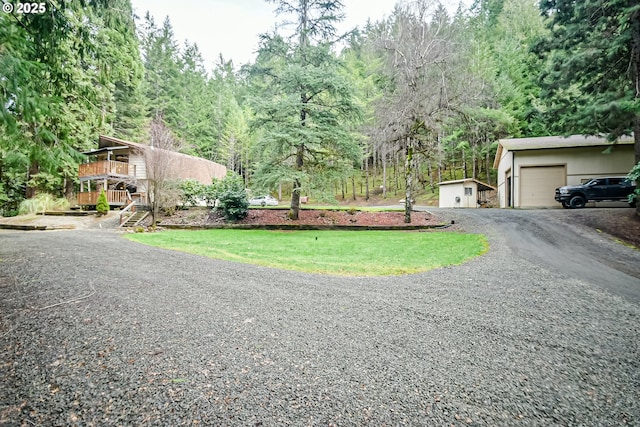 view of road with gravel driveway and stairway