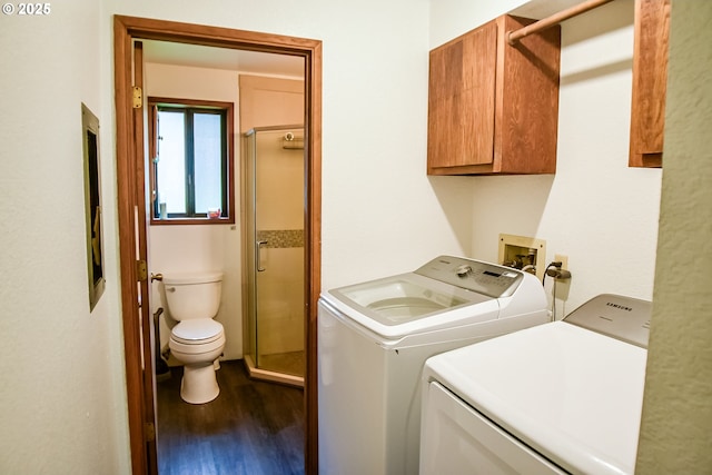 clothes washing area with laundry area, dark wood-style flooring, and washing machine and clothes dryer