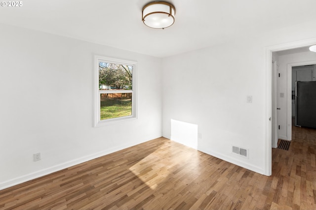 spare room featuring hardwood / wood-style floors