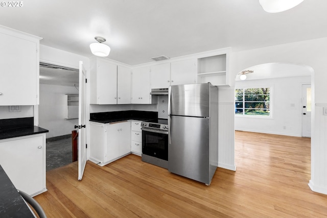 kitchen with white cabinets, light wood-type flooring, and appliances with stainless steel finishes