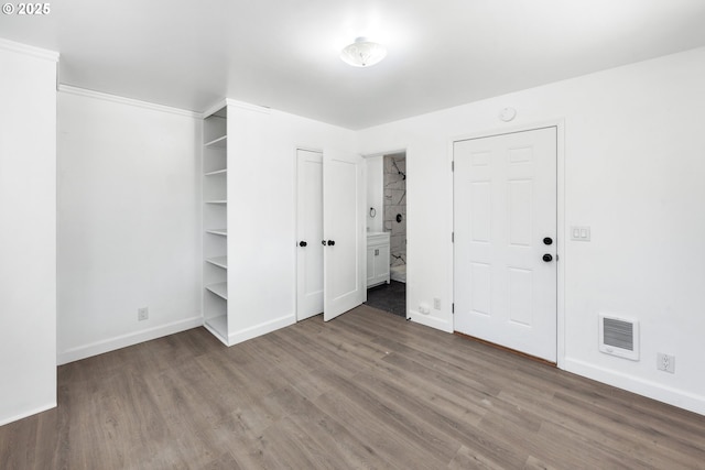 unfurnished bedroom with hardwood / wood-style flooring