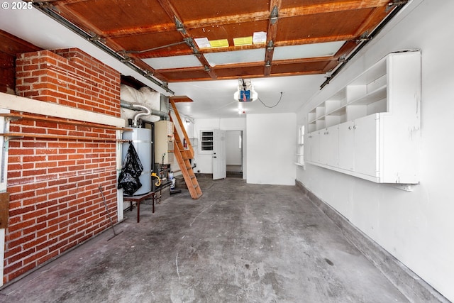 garage with water heater and a garage door opener