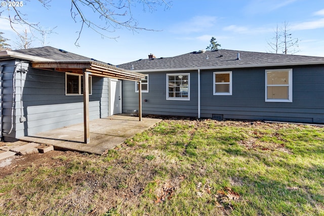 back of property featuring a patio area and a yard