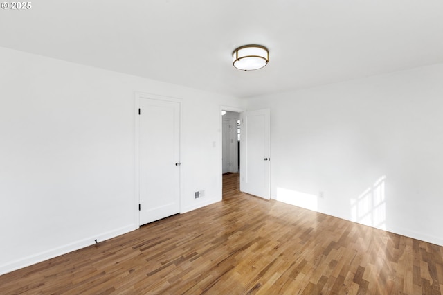 spare room featuring hardwood / wood-style flooring