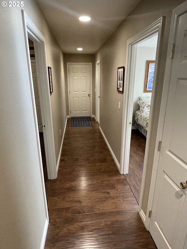 hall with baseboards, dark wood-style flooring, and recessed lighting