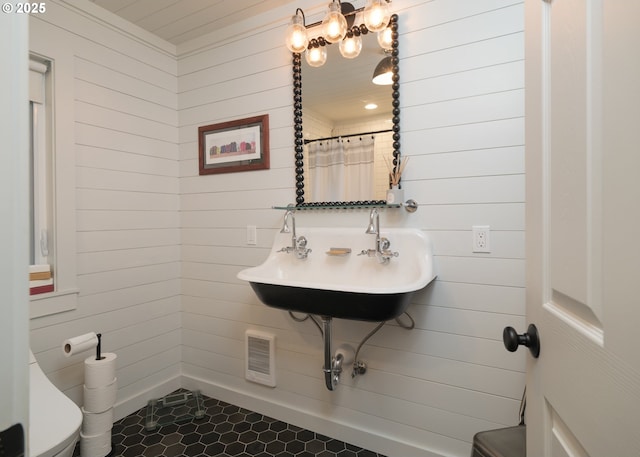 762 G St, Gearhart, OR 97138 - bathroom featuring wooden walls and tile patterned floors