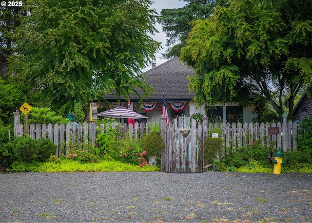 762 G St, Gearhart, OR 97138 - view of front of property featuring a shingled roof and a gate